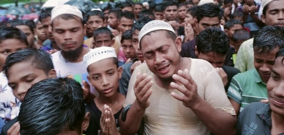 Aerial view of a large crowd of Rohingya refugees gathered peacefully at a Cox’s Bazar refugee camp in Bangladesh.