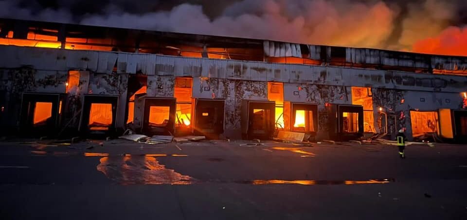 Emergency crews working near damaged buildings following an explosion outside Kyiv
