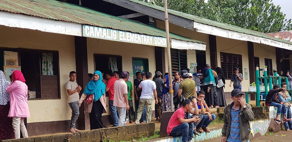 Voters queue at a polling station during the Bangsamoro parliamentary elections in Cotabato City