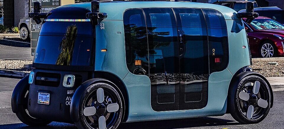 An autonomous driverless robotaxi operating on a public city road.