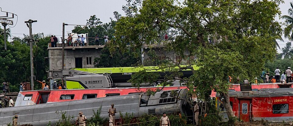 Emergency crews and railway investigators inspecting damaged high-speed train carriages after a fatal train collision in Spain.